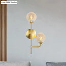 Modern brass sphere wall sconce amber & smoke gray bathroom light