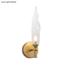 Modern brass torch sconce with clear glass bedroom wall lamp