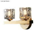 Modern brass wall light with clear crystal block for living room
