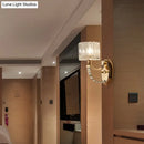 Modern brass wall sconce bedroom light with faceted clear glass shade