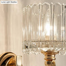 Modern brass wall sconce bedroom light with faceted clear glass shade