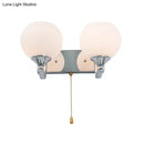 Modern chrome and cream glass wall light bedroom sconce with pull chain