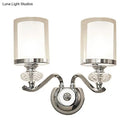 Modern chrome dual cylinder bathroom sconce with curvy arm