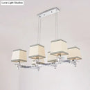 Modern chrome island pendant light with cream shades for dining rooms