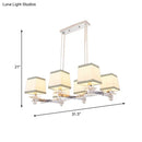 Modern chrome island pendant light with cream shades for dining rooms