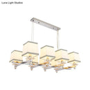 Modern chrome island pendant light with cream shades for dining rooms