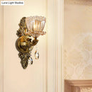 Modern floral brass wall sconce with teardrop crystal drop living room