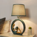 Modern girl reading teal resin night lamp with fabric shade bedroom