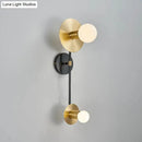 Modern gold and black wall sconce with opal glass shade bedroom light