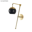 Modern gold and clear black glass ball sconce – bedroom wall light