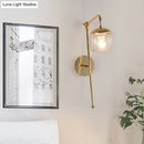 Modern gold and clear black glass ball sconce – bedroom wall light