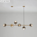 Modern gold and smoke gray globe hanging light – dining room island