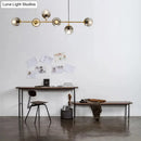 Modern gold and smoke gray globe hanging light – dining room island
