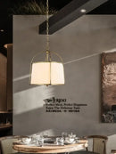 Modern gold & black pendant lights with fabric shades dining room