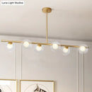 DecorBites™ Nordic Metal 6-Head Linear Island Light with Gold Finish and Clear Glass Globes