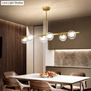 DecorBites™ Nordic Metal 6-Head Linear Island Light with Gold Finish and Clear Glass Globes