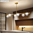 DecorBites™ Nordic Metal 6-Head Linear Island Light with Gold Finish and Clear Glass Globes