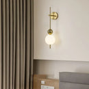 Modern gold led wall sconce with frosted glass spheres for bedroom