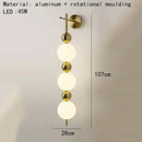 Modern gold led wall sconce with frosted glass spheres for bedroom