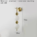 Modern gold led wall sconce with frosted glass spheres for bedroom