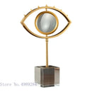 Modern gold metal eye magnifying glass with glass base living room decor