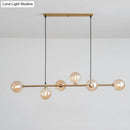 Modern gold metal island pendant with blue glass spheres dining room
