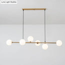 Modern gold metal island pendant with blue glass spheres dining room