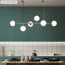 Modern gold metal island pendant with blue glass spheres dining room