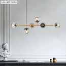 Modern gold metal island pendant with blue glass spheres dining room