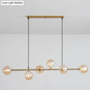Modern gold metal island pendant with blue glass spheres dining room