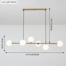 Modern gold metal island pendant with blue glass spheres dining room