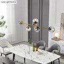 Modern gold metal island pendant with blue glass spheres dining room