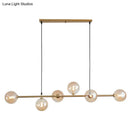 Modern gold metal island pendant with blue glass spheres dining room