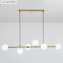 Modern gold metal island pendant with blue glass spheres dining room