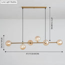 Modern gold metal island pendant with blue glass spheres dining room
