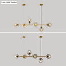 Modern gold metal island pendant with blue glass spheres dining room
