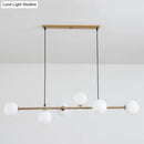 Modern gold metal island pendant with blue glass spheres dining room