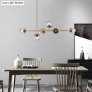 Modern gold metal island pendant with blue glass spheres dining room