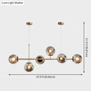 Modern gold metal island pendant with blue glass spheres dining room