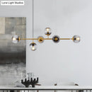 Modern gold metal island pendant with blue glass spheres dining room