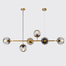 Modern gold metal island pendant with blue glass spheres dining room