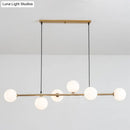 Modern gold metal island pendant with blue glass spheres dining room