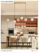 Modern gold metal island pendant with blue glass spheres dining room
