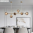 Modern gold metal island pendant with blue glass spheres dining room