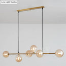 Modern gold metal island pendant with blue glass spheres dining room
