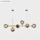 Modern gold metal island pendant with blue glass spheres dining room