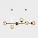 Modern gold metal island pendant with blue glass spheres dining room