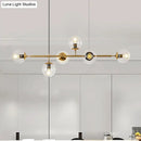 Modern gold metal island pendant with blue glass spheres dining room