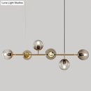 Modern gold metal island pendant with blue glass spheres dining room