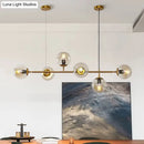 Modern gold metal island pendant with blue glass spheres dining room